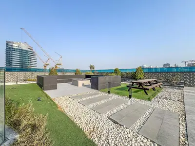 a park with a bench and a picnic table at Modern Studio - near Dubai Hills Mall - Pool & Gym in Dubai