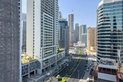 an aerial view of a city with tall buildings at Elegant 1BR with Canal Views in Business Bay in Dubai