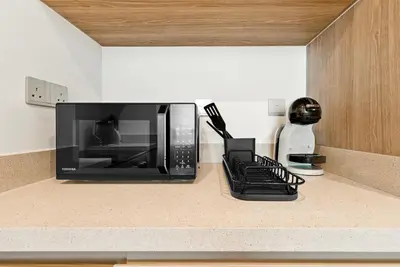 a microwave sitting on a counter in a kitchen at BLVD - Missoni Living - Close to Burj Khalifa in Dubai