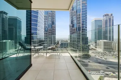 a balcony with chairs and a view of a city at BLVD - Missoni Living - Close to Burj Khalifa in Dubai