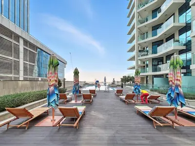 a row of beach chairs and umbrellas on a boardwalk at BLVD - Missoni Living - Close to Burj Khalifa in Dubai
