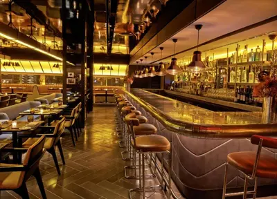 a bar with a row of stools in a restaurant at PARAMOUNT TOWER B BUSINESS Bay Lux 1 bedroom Apt in Dubai