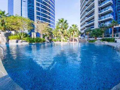 a large swimming pool in a city with tall buildings at PARAMOUNT TOWER B BUSINESS Bay Lux 1 bedroom Apt in Dubai