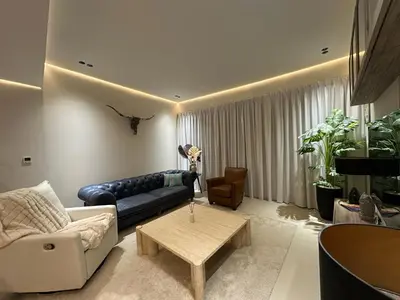 a living room with a couch and a table at Cozy Apartment Dubai Silicon Arch in Dubai