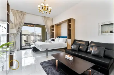 a living room with a bed and a couch at Bookable- Studio Resortz By Danube with Balcony in Dubai