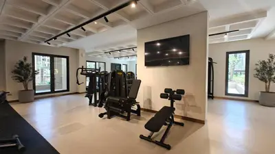 a gym with several exercise equipment in a room at StayShort - MJL Apartment for 2 people near Water Parks in Dubai