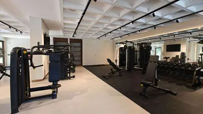 a gym with several treadmills and machines in it at StayShort - MJL Apartment for 2 people near Water Parks in Dubai