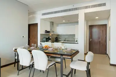 a kitchen and dining room with a table and chairs at Gorgeous 2BR in DIFC close to Metro & Dubai Mall in Dubai