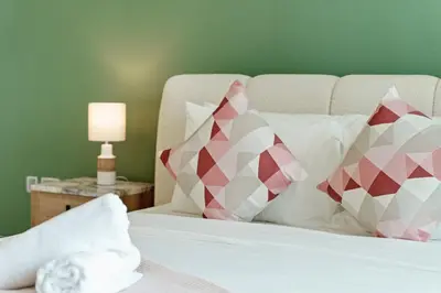 a bedroom with a bed with pillows and a lamp at Gorgeous 2BR in DIFC close to Metro & Dubai Mall in Dubai