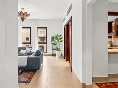 a living room with a couch and a table at Spacious 2BR Steps from Downtown in Dubai