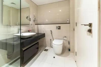 a bathroom with a toilet and a sink at Downtown Dubai Studio Apartment - High floor in Dubai
