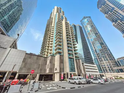 a tall building with cars parked in a city at BLVD - Stylish Missoni Stay - Canal View in Dubai