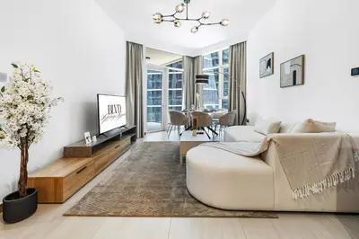 a white living room with a couch and a table at BLVD - Stylish Missoni Stay - Canal View in Dubai
