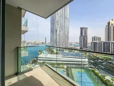 a balcony with a view of a city at Deluxe 1-Bedroom in The Grand - Waterfront and Skyline Views in Dubai