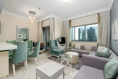 a living room with a couch and a table at Elegant 2BR APT, 3 minutes to Burj Khalifa in Dubai