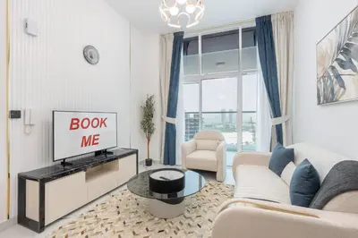 a living room with a couch and a tv at StayShort - Al Barsha Apartment Sleeps 2 with Private Balcony in Dubai
