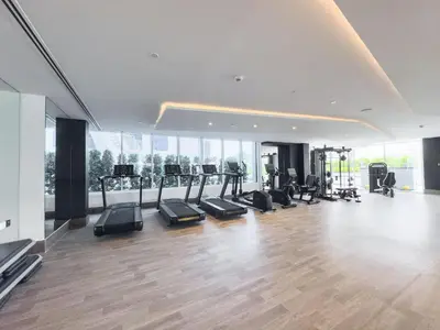 a gym with treadmills and exercise equipment in a building at StayShort - Al Barsha Apartment Sleeps 2 with Private Balcony in Dubai