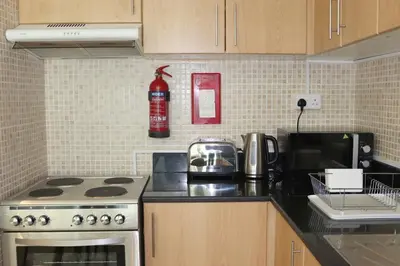 a kitchen with a stove and a microwave at Water View I Chic 1BR I Mayfair I 3 Sleeps I Fast Wi-Fi I Walkable Area in Dubai