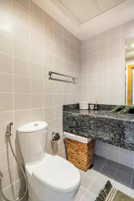 a bathroom with a white toilet and a sink at Water View I Chic 1BR I Mayfair I 3 Sleeps I Fast Wi-Fi I Walkable Area in Dubai