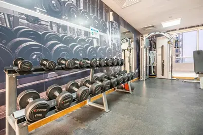a gym with rows of dumbbells on the wall at Water View I Chic 1BR I Mayfair I 3 Sleeps I Fast Wi-Fi I Walkable Area in Dubai