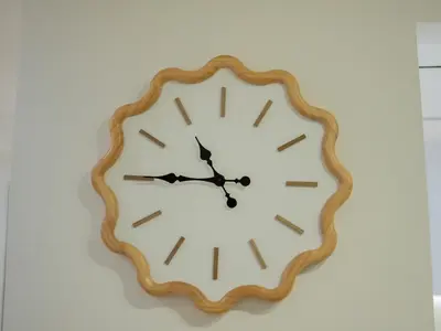 a clock is on a white wall at Binghatti Crest in Dubai