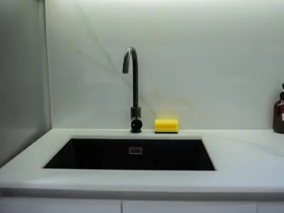 a sink in a kitchen with a black sink at Binghatti Crest in Dubai