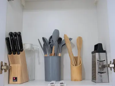 a container of utensils sitting on a counter at Binghatti Crest in Dubai