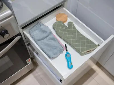 a drawer in a kitchen with a pair of scissors at Binghatti Crest in Dubai
