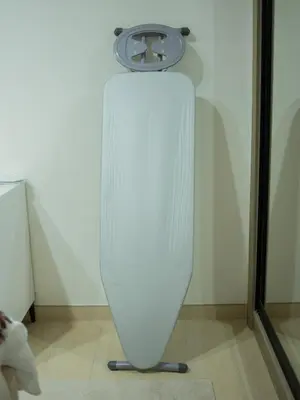a white surfboard on a stand in a room at Binghatti Crest in Dubai