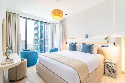 a hotel room with a large bed and a large window at Incredibly Elegant 1BDR with full Marina Views in Dubai