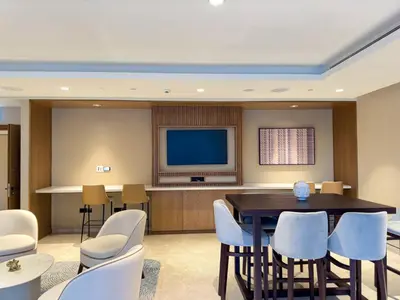 a conference room with a table and chairs and a television at Beautiful 2BR with Burj Khalifa Views in Dubai