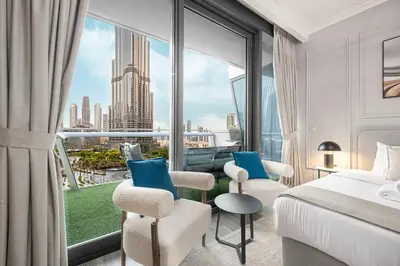 a hotel room with a bed and a large window at Luxury Burj Vista Suites by Mystique - Breathtaking Burj Khalifa Views in Dubai