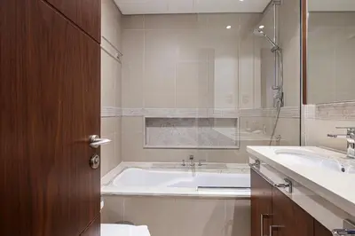 a bathroom with a tub and a sink at Luxury Burj Vista Suites by Mystique - Breathtaking Burj Khalifa Views in Dubai