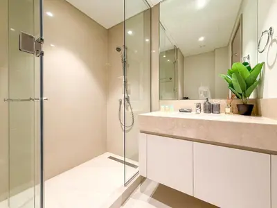 a bathroom with a shower and a sink at Act 1 Act 2 Towers, Luxury 4BR, Full Burj Khalifa View Balcony, Pool, Gym in Dubai