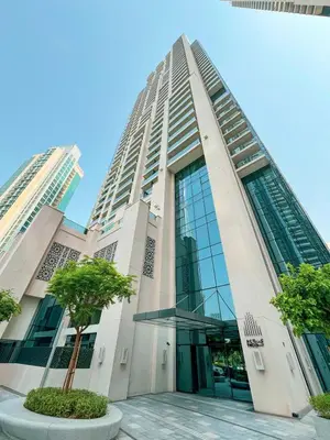 a tall building with trees in front of it at Act 1 Act 2 Towers, Luxury 4BR, Full Burj Khalifa View Balcony, Pool, Gym in Dubai