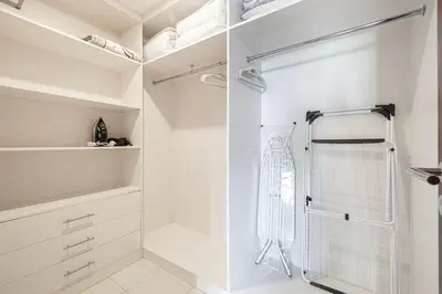 a bathroom with a shower and a walk in closet at Stunning 2BR with Panoramic Burj & Fountain view in Dubai