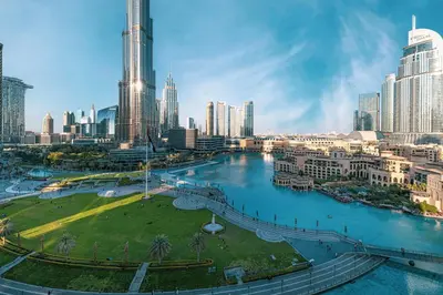 a view of a city with a river and buildings at Stunning 2BR with Panoramic Burj & Fountain view in Dubai