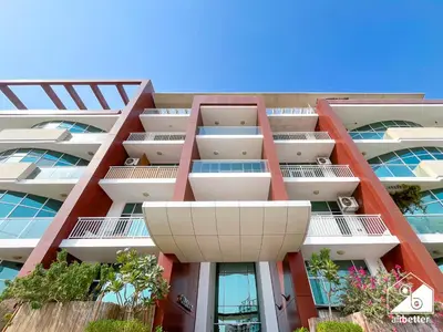 an apartment building with red and white balconies at Urban Duplex Hideaway l Gym, Pool & Balcony in Dubai