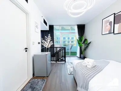 a white bedroom with a bed and a window at Urban Duplex Hideaway l Gym, Pool & Balcony in Dubai