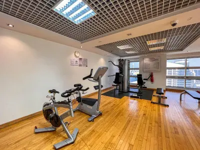 a gym with treadmills and exercise equipment in a building at Cozy Studio with Sofa bed beside DMCC Metro & Dubai Marina in Dubai