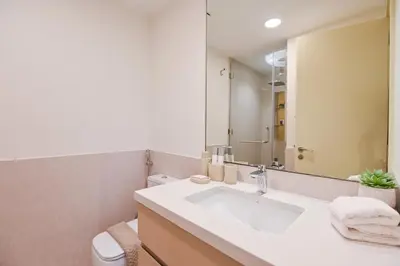 a bathroom with a sink and a mirror at GV Holiday Homes DXB - Cozy 2BR Apartment in Town Square Dubai in Dubai