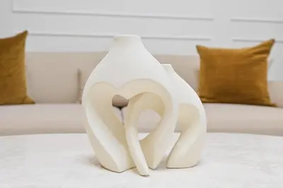 a white vase sitting on top of a table at GV Holiday Homes DXB - Cozy 2BR Apartment in Town Square Dubai in Dubai