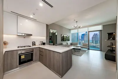a large kitchen with a counter and a living room at Exciting 1BR apartment Liv Marina in JBR in Dubai