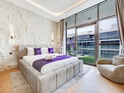 a bedroom with a large bed and a large window at Modern 2BR Gem Full Golf Views & Pool in Dubai
