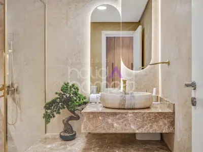 a bathroom with a large sink and a mirror at Modern 2BR Gem Full Golf Views & Pool in Dubai