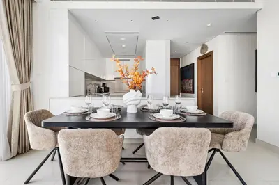 a dining room with a black table and chairs at 2BR plus Maid CF7 B Stylish Stay with Large Balcony in Dubai