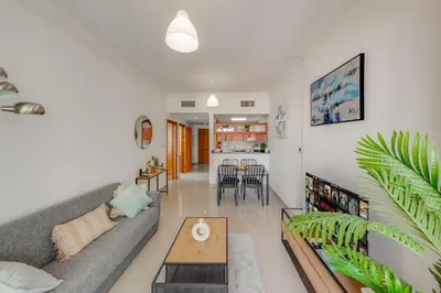 a living room with a couch and a table at Spacious 1BR in Great Location, Manchester Tower, Dubai Marina in Dubai