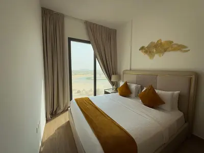 a bedroom with a large bed with a large window at 1 Bedroom Apartment in Liva by the S Holiday Homes in Dubai