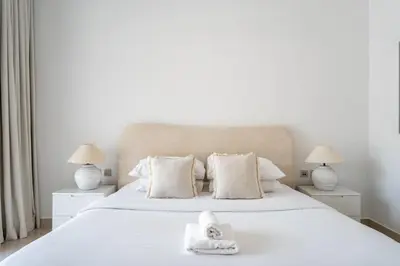 a bedroom with a white bed with towels on it at GuestReady - Luxury 2BD w/ balcony | Business Bay in Dubai