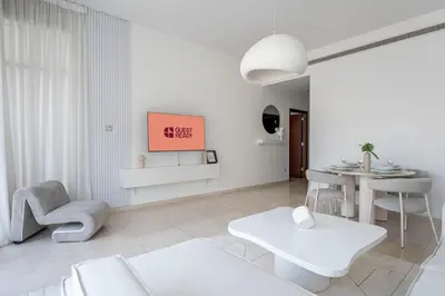 a living room with white furniture and a table at GuestReady - Luxury 2BD w/ balcony | Business Bay in Dubai